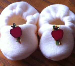 Finished plush baby booties with trim