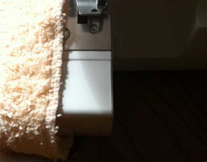 Overlock stitch on frayed towel