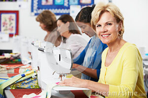 group-women-using-electric-sewing-machines-class-smiling-33563232